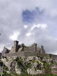 The sky is gray, except for a patch of blue directly over the castle.