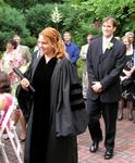 Rev. Cherie walks through the garden with Brian.