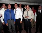 The single guys wait for the garter to be tossed.