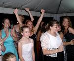 The single ladies cheer as the bride prepares to throw her bouquet.