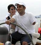Valerie laughs as she watches her husband Leo sail for the first time.  Leo lost his arm 6 months ago in Iraq.
