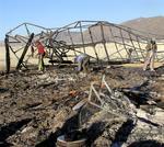 Scavenging through the rubble of the temple burn.