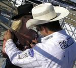 Kristy gets her chest signed by a rodeo star.