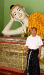 Eddy by a reclining Buddha after finally returning to his homeland (Myanmar) after 44 years.
