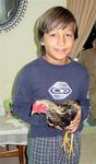 My nephew Tyler with the family's pet chicken.