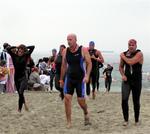 In thew swim, Cherie catches up to guys who started two waves ahead of her. (Notice the red cap!)