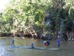 Edna floats by on a bamboo raft.