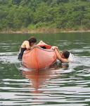 This is called: Diane gets into the canoe.