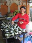 A Balinese girl preparing the days offerings.