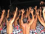 The bare-chested choir, called gamelan suara, raises their hands and sways during the performance.