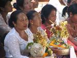 Women with baskets loaded with offerings.