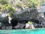 A cave by the crystal blue sea.