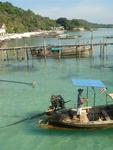 A long boat driver zooms by.