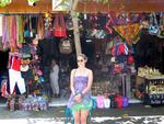 Hannah in front of a tourist shop.