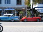 Cherie between two classic cars.