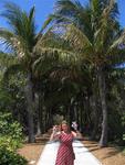 Cherie near a canopy of palms.