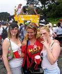 A couple of white trash chicks just hangin' by a monster truck.