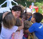 Everyone gives the birthday girl a group hug.