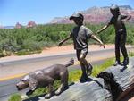 Bronze children playing by the road.