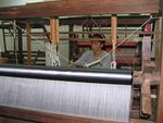 Weaving raw silk into fabric.