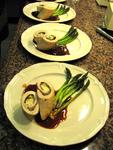 Course 4 is culinary art: Chicken stuffed with basil, proscuitto, and goat cheese roulade garnished with roasted asparagus.