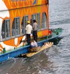 Don't feel too bad for these guys on bamboo rafts--Scott bought a Buddha statue, and paid 3-times its value.