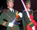 Guards patrol the gates at night.