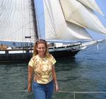 Cherie surrounded by billowing canvas of a tallship. *Photo by Norm.