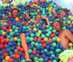 Who said we ever have to grow up?  Cherie, Margaret, Vicky and Brian jump in a vat of plastic balls at Burning Man 2005.