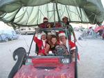 Cherie takes a ride on a sleigh adapted for the Black Rock Desert.