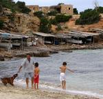 A family frolicks by the sea.