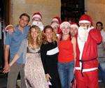 Eric, Hannah and Cherie with a bunch of Santas.