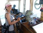 Mika takes over control of the ferry.  When it is your first time driving a boat, you should always have lots of passengers.