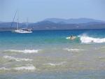 Surfers share the sea with boats. 