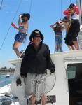 Richard at the helm, with the ladies on deck. *Photo by Rennie.