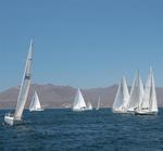 White sails on a blue sea. *Photo by Karen Vaccaro S/V Miela.