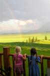Jaden and Maria stare in awe as a rainbow arches over the Gardiner Prime Angus Ranch.