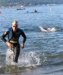 The first swimmers splash out of the water.