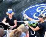 The winners celebrate their victory with champagne.