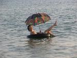 Jean in the water with an umbrella.