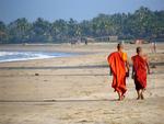 Monks walking on Ngwe Saung Beach.