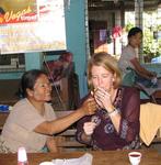 Jean enjoys a cheroot with the owner.