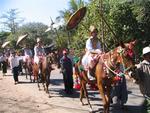 The young monks-to-be are escorted through town on horseback.