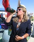 Captain Anne takes a swig of bubbly grog.