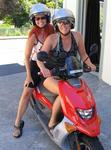 Cherie and Marjo rent a moped to explore the cottages around Akaroa, New Zealand.