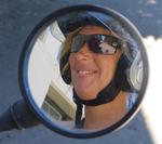 Marjo in the rear view mirror.  Don't mess with a girl in a helmet.