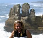 Cherie with the sculpted limestone sea stacks called "the Pancake Rocks" because the unique rock layers look like pancakes piled on top of each other.