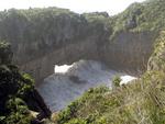 A pocket of water, carved out by the crash of the Tasman Sea, creates a land-bridge.