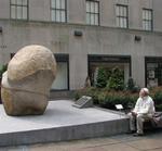 Man examines rock.