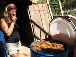 Camelia tastes the agave pulp fermenting in the barrel.
